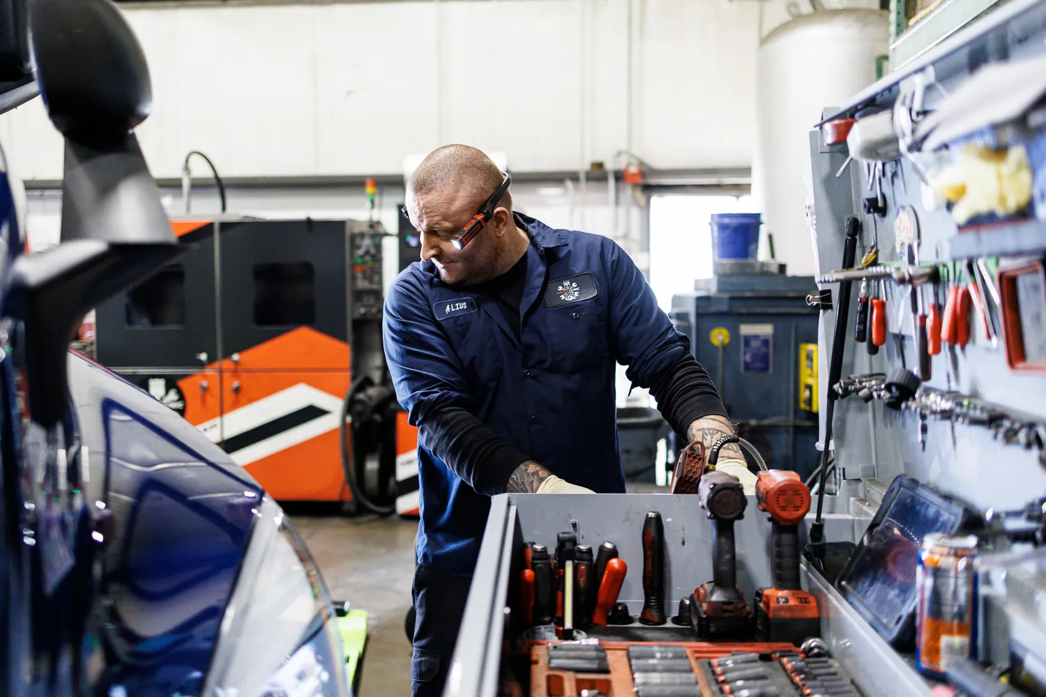 Truck Clinic technician beside a tool cabinet in the workshop