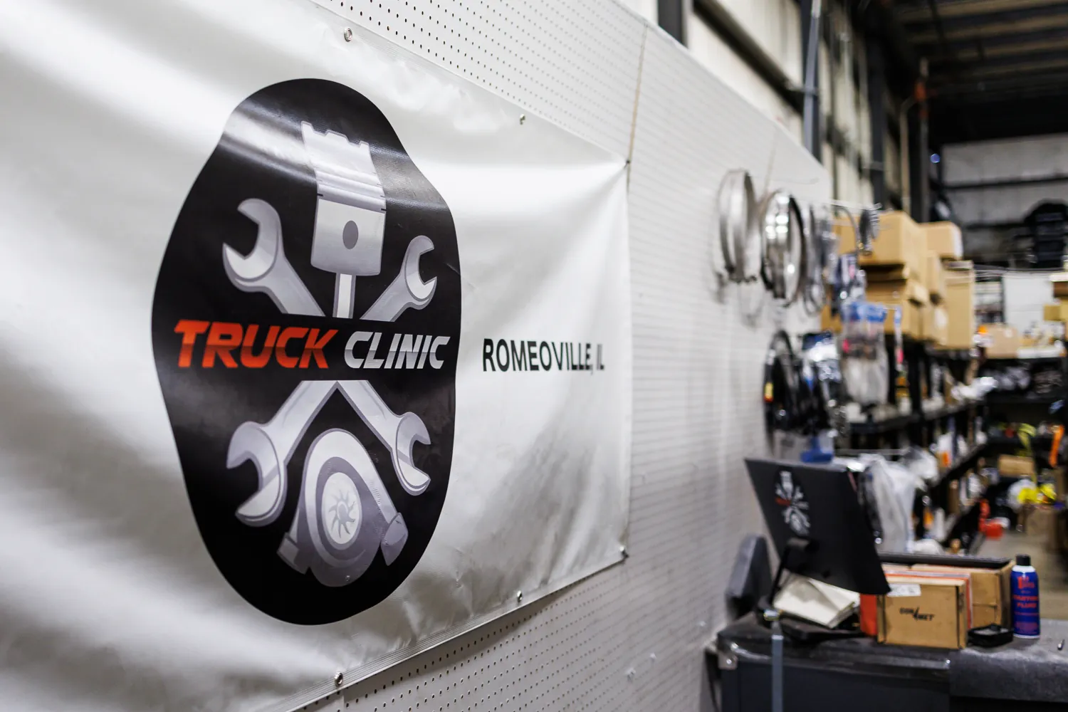 Truck Clinic's Romeoville banner on the workshop wall