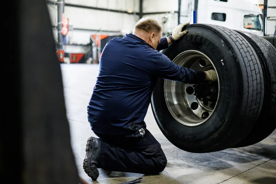 A commercial truck raised for inspection at Truck Clinic in Romeoville, IL