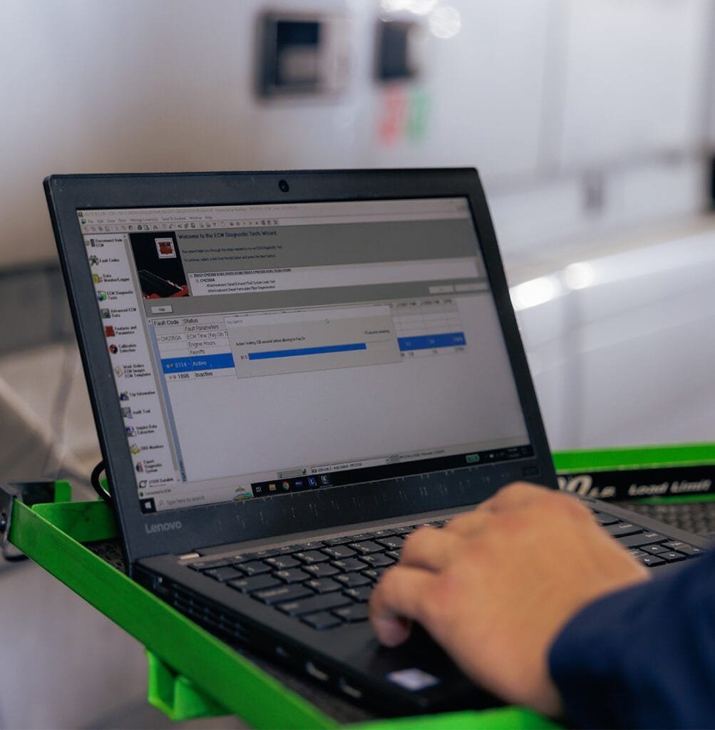 person doing a truck diagnostic using his laptop