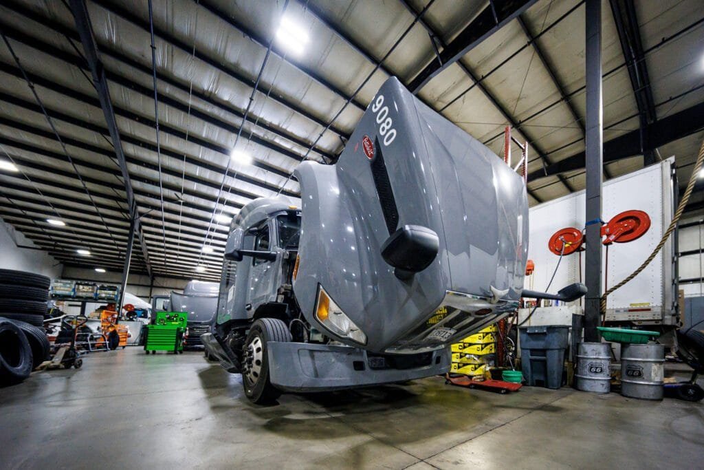 gray truck with hood open