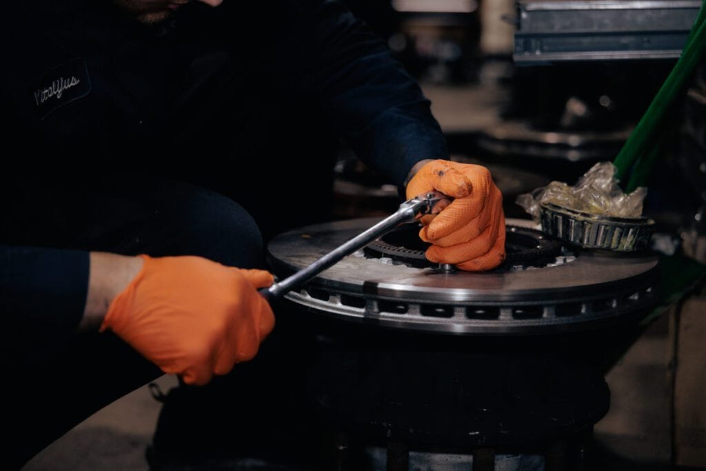 person doing truck repair for a truck part